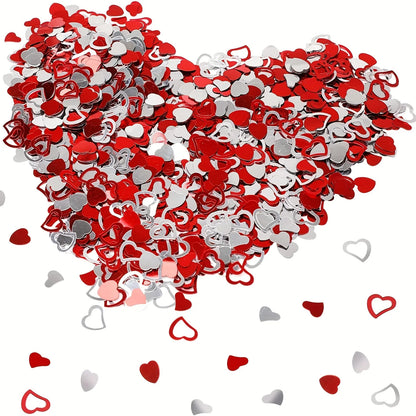 Heart-shaped confetti in red and silver on a white background