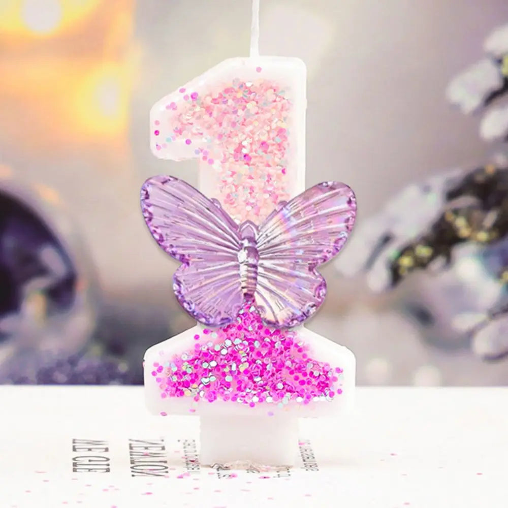 Butterfly-shaped candle with pink glitter on a blurred background