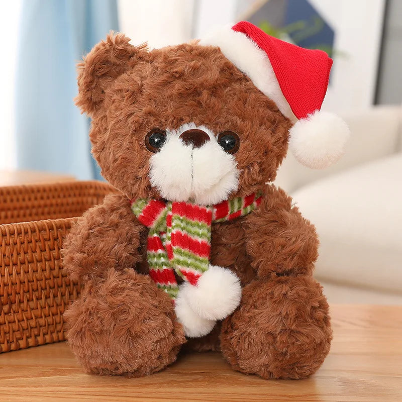 Brown teddy bear wearing a red Santa hat and striped scarf on a wooden surface.