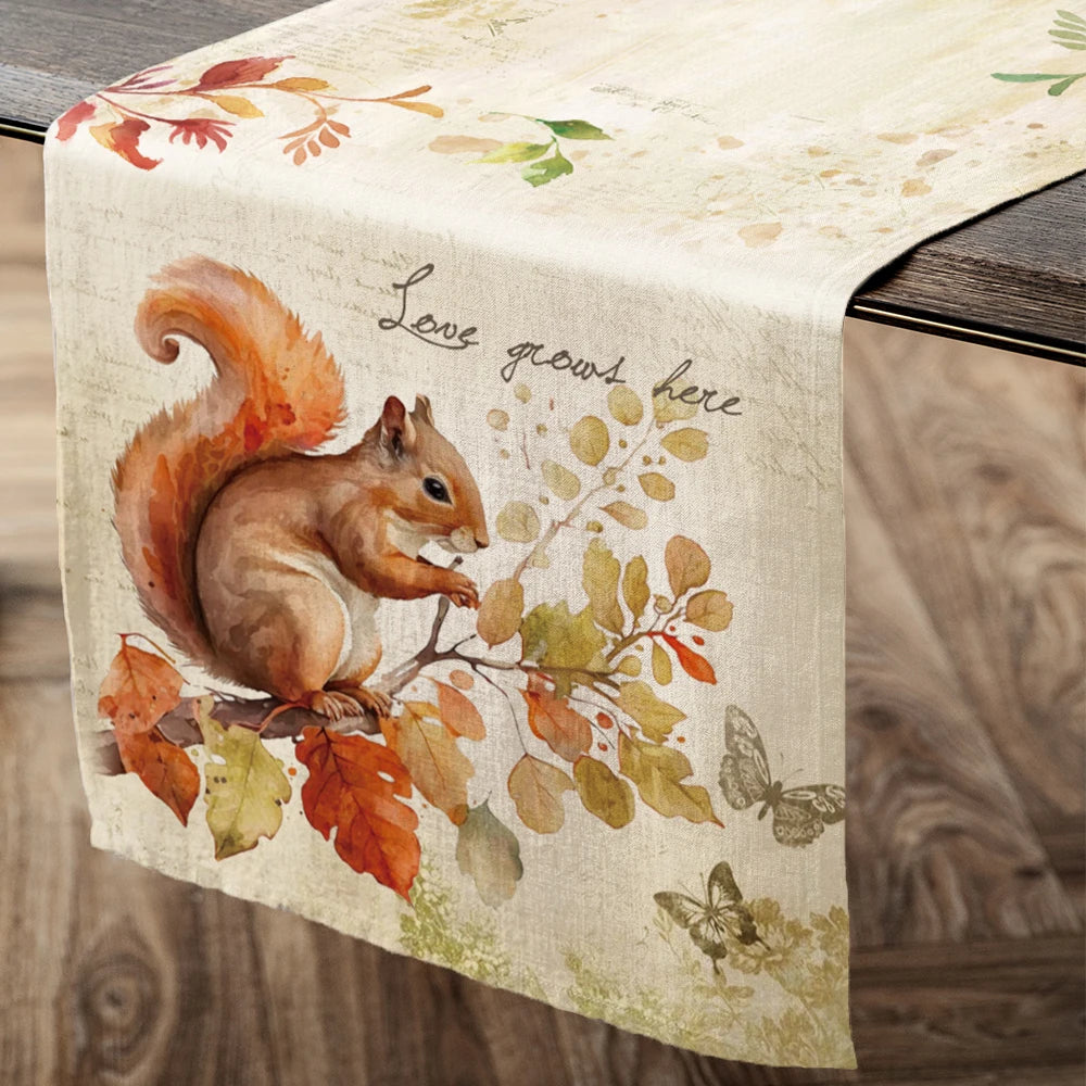 Table runner with a squirrel design and 'Love grows here' text on a wooden table.