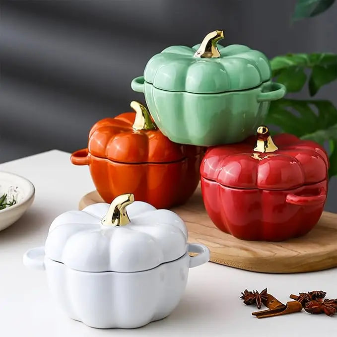 Set of colorful ceramic pumpkin-shaped pots on a wooden board with a gray background.