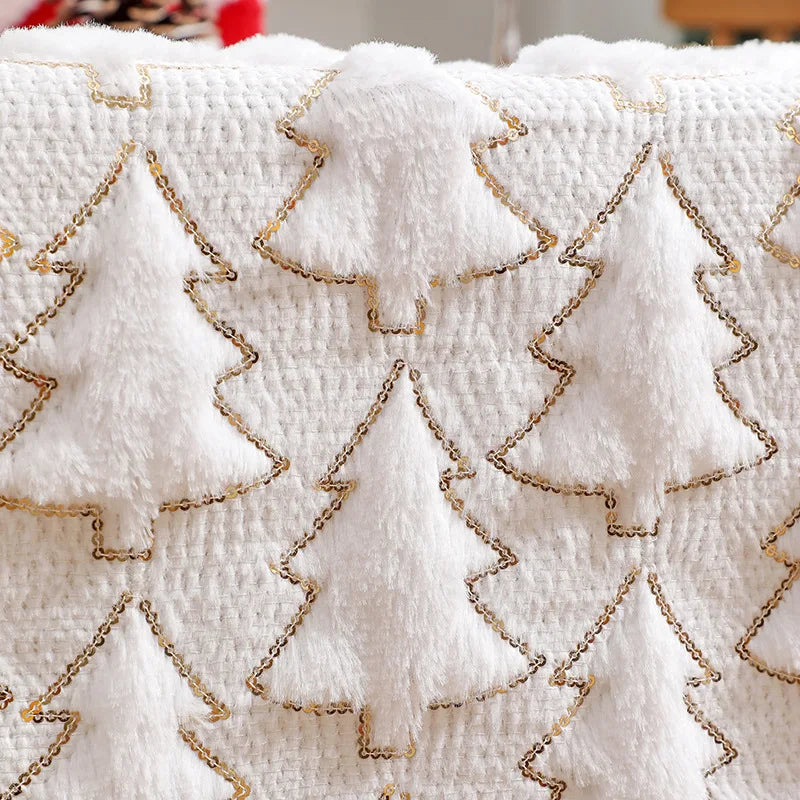 White fabric with gold embroidered tree patterns on a blurred background
