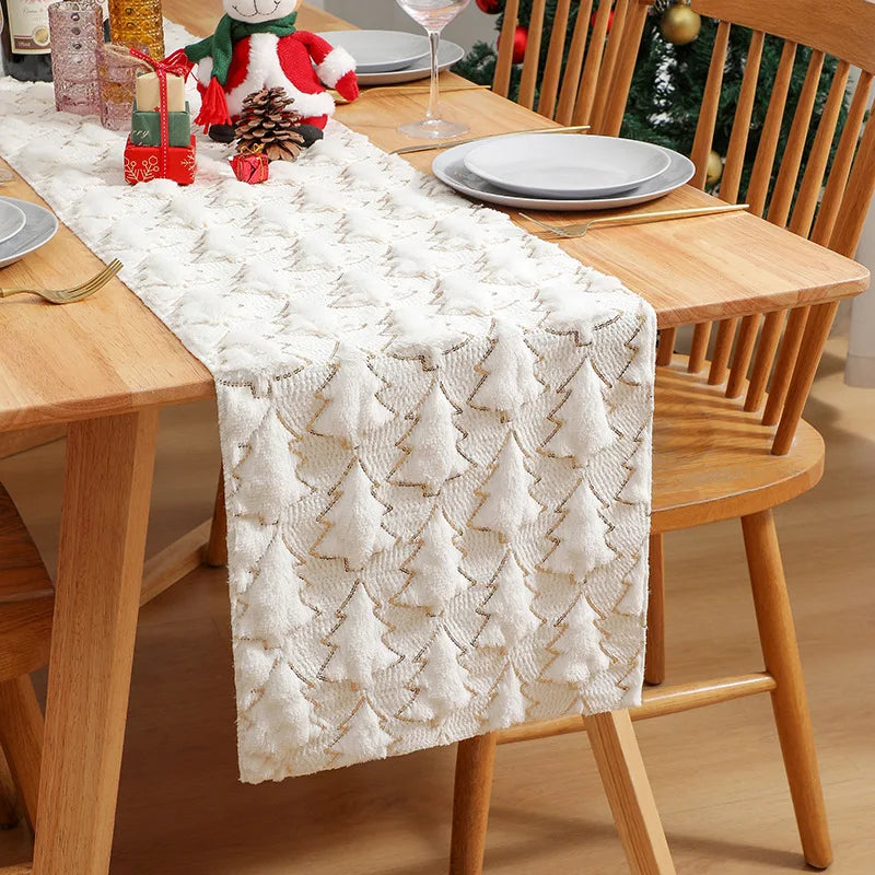 Dining table set with a textured white table runner, plates, and decorative items.