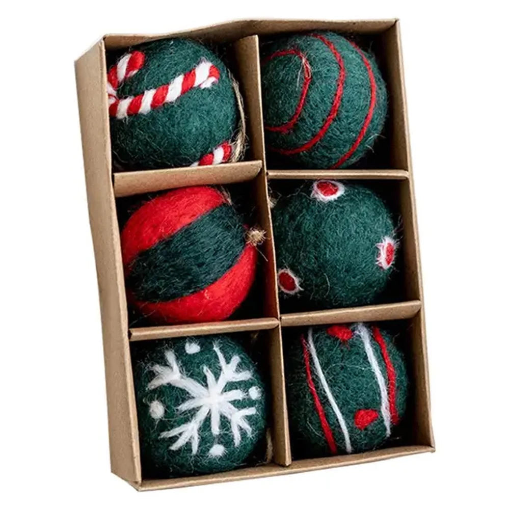 Set of six green felt ornaments with festive patterns in a cardboard box.
