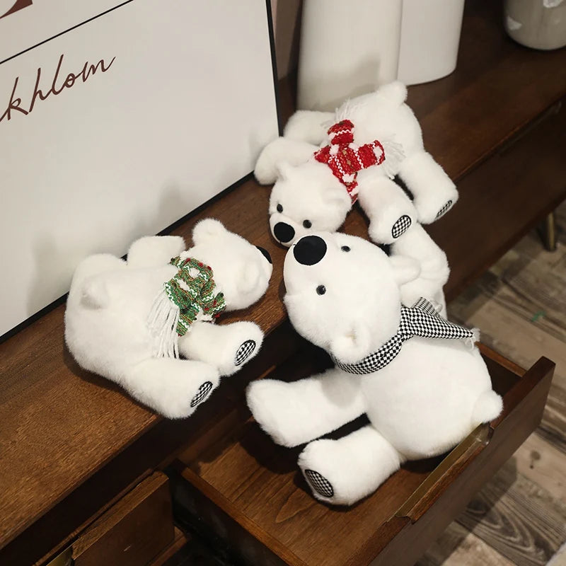 Three white teddy polar bears with decorative bows on a wooden surface.