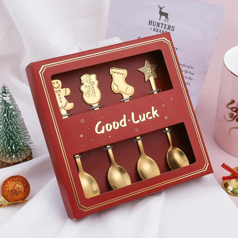 Set of gold Christmas-themed spoons in a red box with 'Good Luck' text, on a white background.