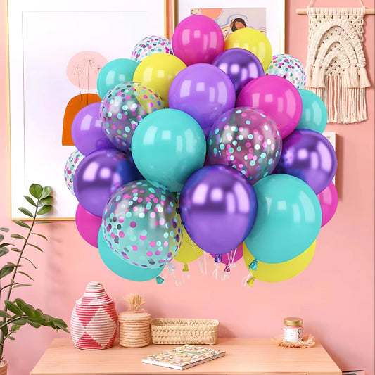 Colorful balloons with polka dots on a pink wall with decor elements.