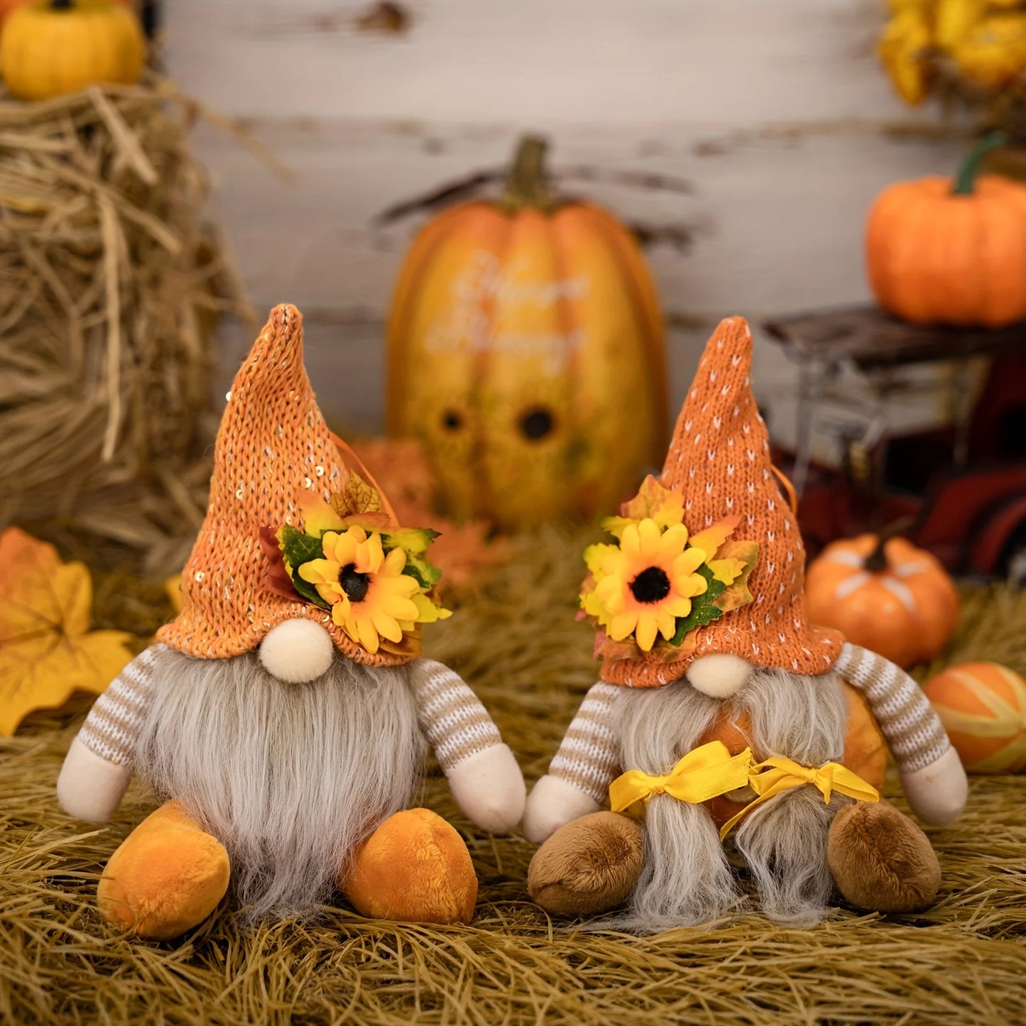 Two autumn-themed gnomes with sunflower hats on a rustic background with pumpkins and hay.