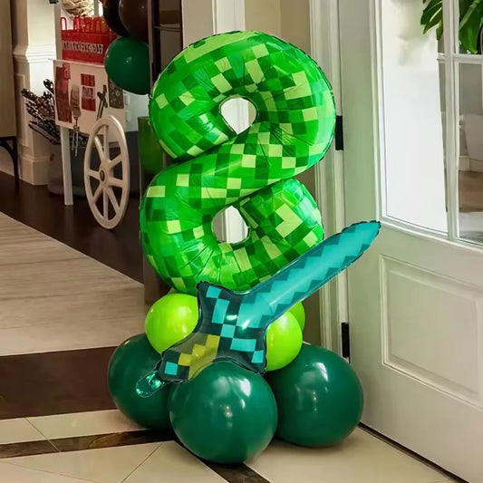 Minecraft creeper balloon in an 8 and diamond sword balloon on top of green balloons in a house setting.