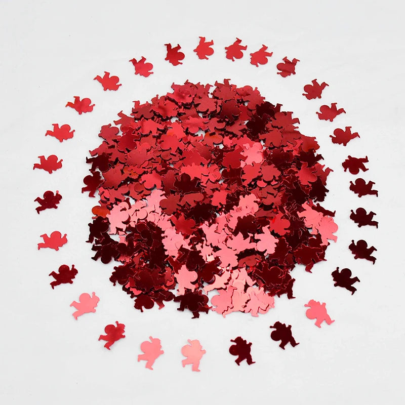 Red and pink heart-shaped confetti on a white background