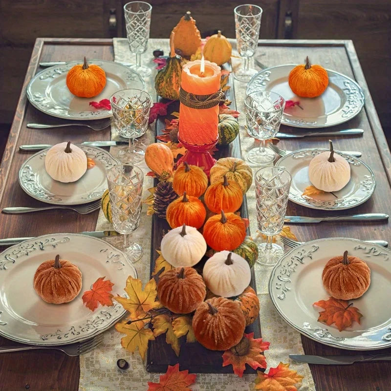 Decorative table setting with pumpkins and candles for a festive atmosphere.
