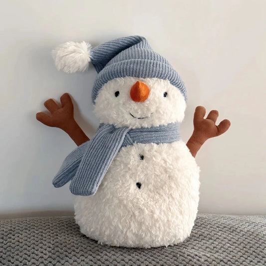 Plush snowman toy with a blue hat and scarf on a neutral background