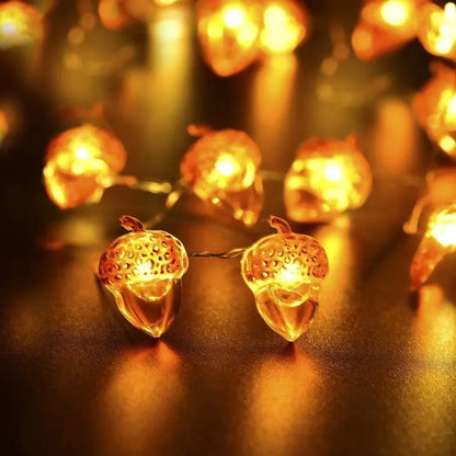 String of acorn-shaped lights on a reflective surface with a blurred background