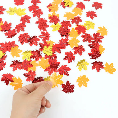 Colorful leaf-shaped confetti on a white background with a hand holding some confetti.