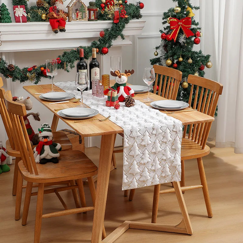 Dining room with Christmas decorations, including a tree, garland, and table setting.