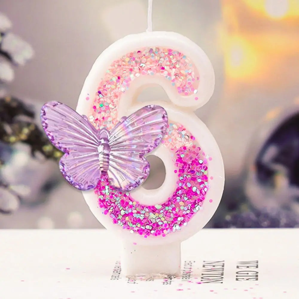 Decorative number '6' with pink glitter and a purple butterfly on a blurred background