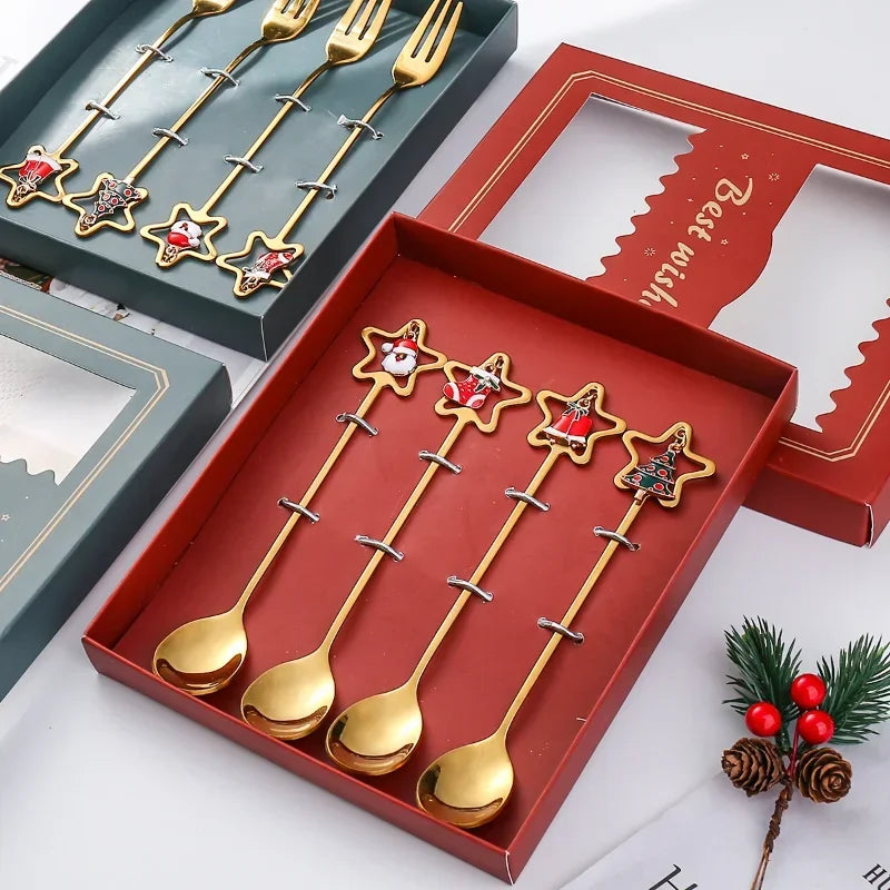 Set of gold star-shaped spoons in a red box with Christmas decorations.
