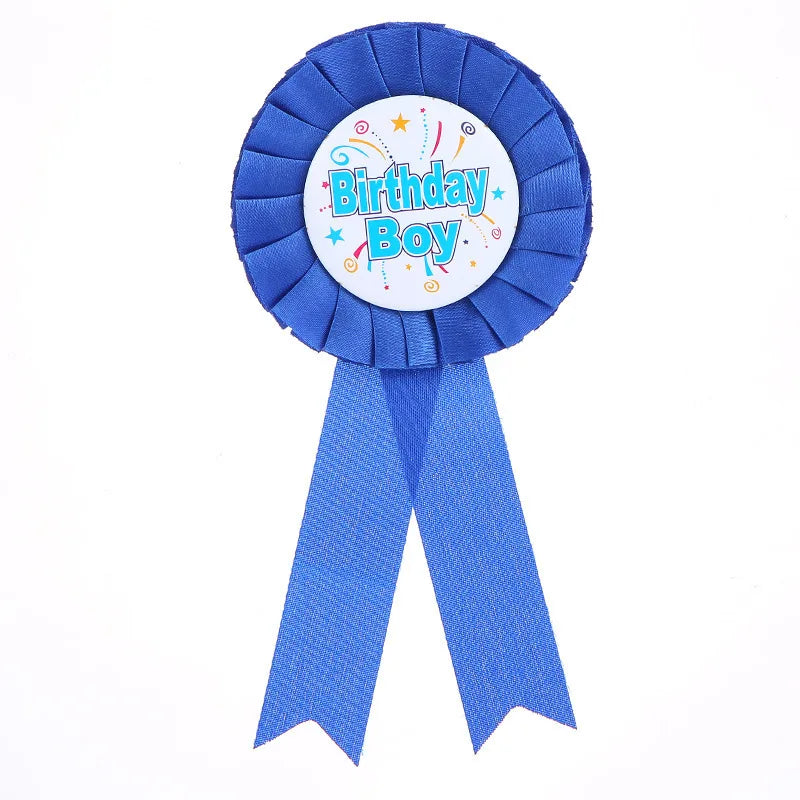 Blue ribbon with 'Birthday Boy' text on a white background