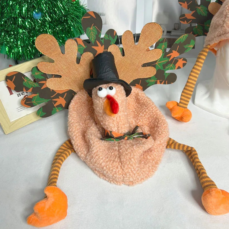 Decorative plush toy resembling a turkey with antlers and a pilgrim hat on a white surface.