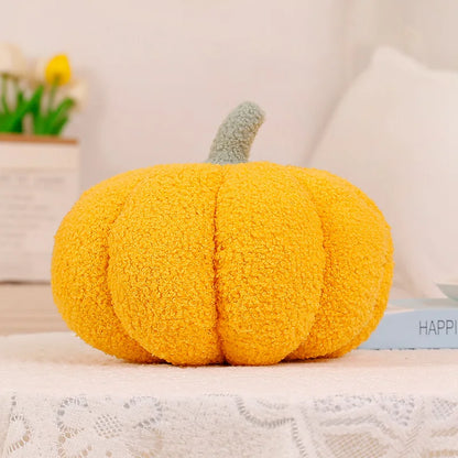 Yellow pumpkin-shaped pillow on a surface with a blurred background
