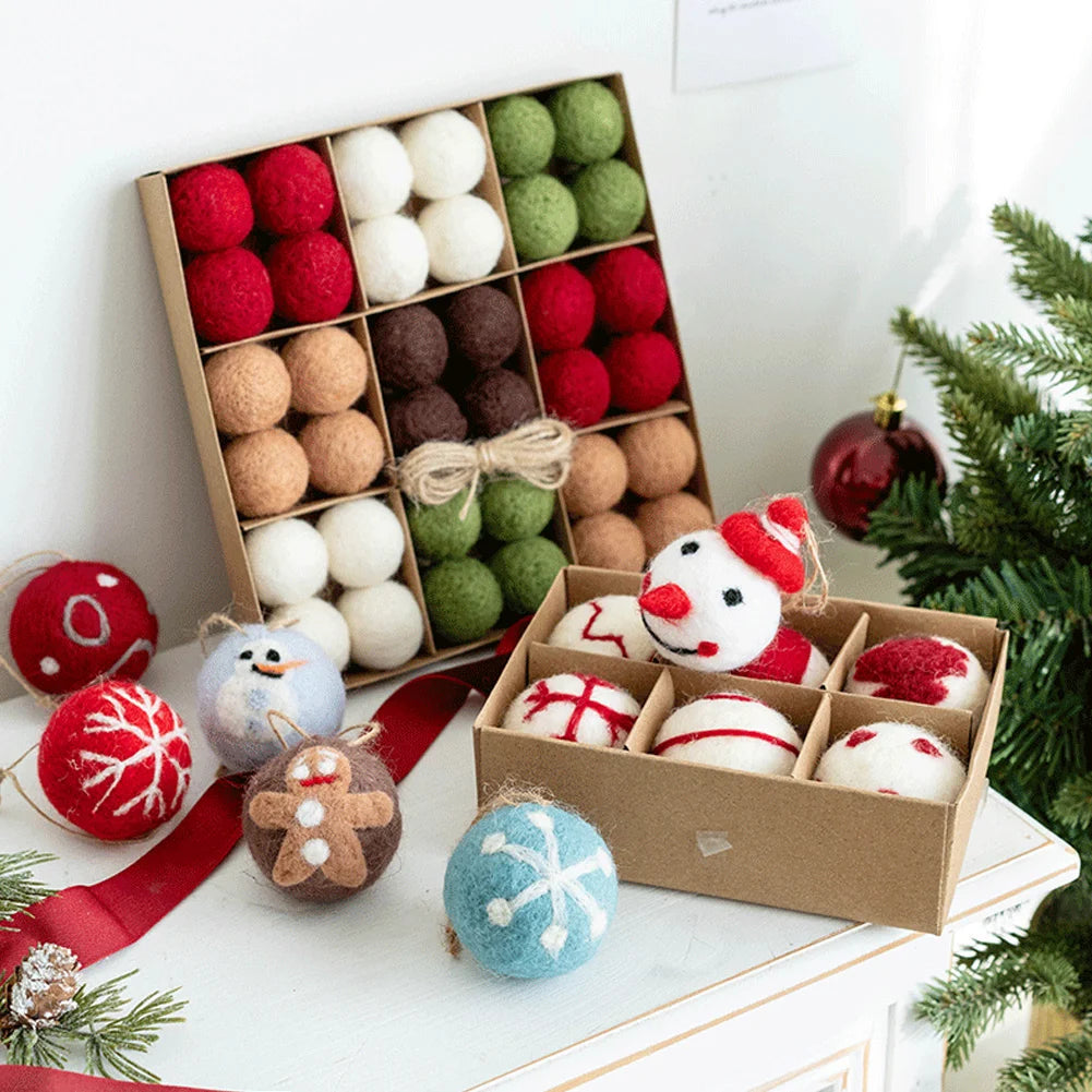 Colorful Christmas ornaments in boxes on a white surface with a Christmas tree in the background.