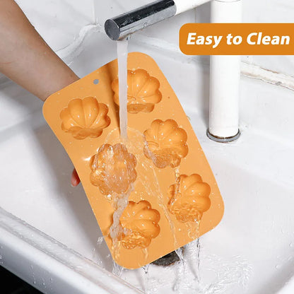 Orange silicone mold being rinsed under running water in a sink with 'Easy to Clean' text displayed.