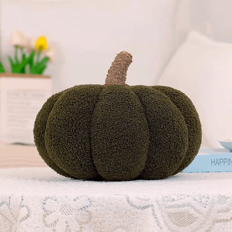 Green textured pumpkin pillow on a surface with a blurred background