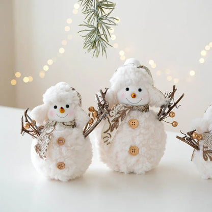 Two decorative snowmen with buttons and a bow tie against a softly blurred background with lights and greenery.