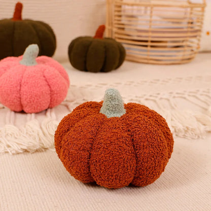 Decorative pumpkins in various colors on a textured surface