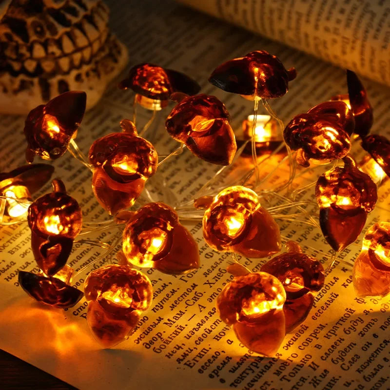 String of small pumpkin-shaped lights on a piece of paper with text.
