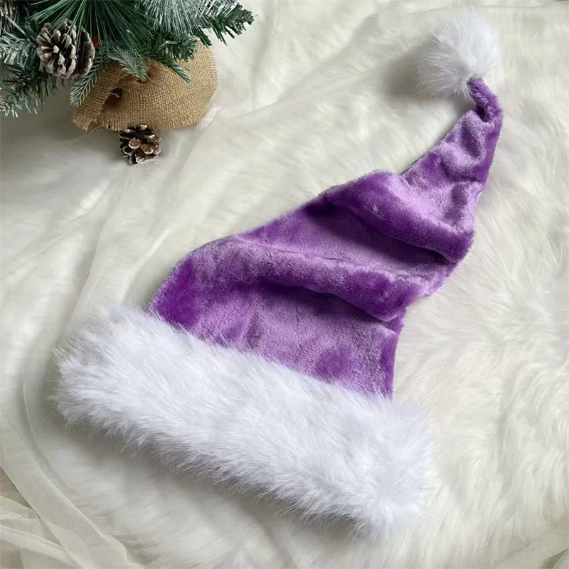 Purple Santa hat with white fur trim on a white fur surface with Christmas decorations.
