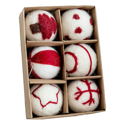 Box of felted wool dryer balls with red and brown patterns on a white background
