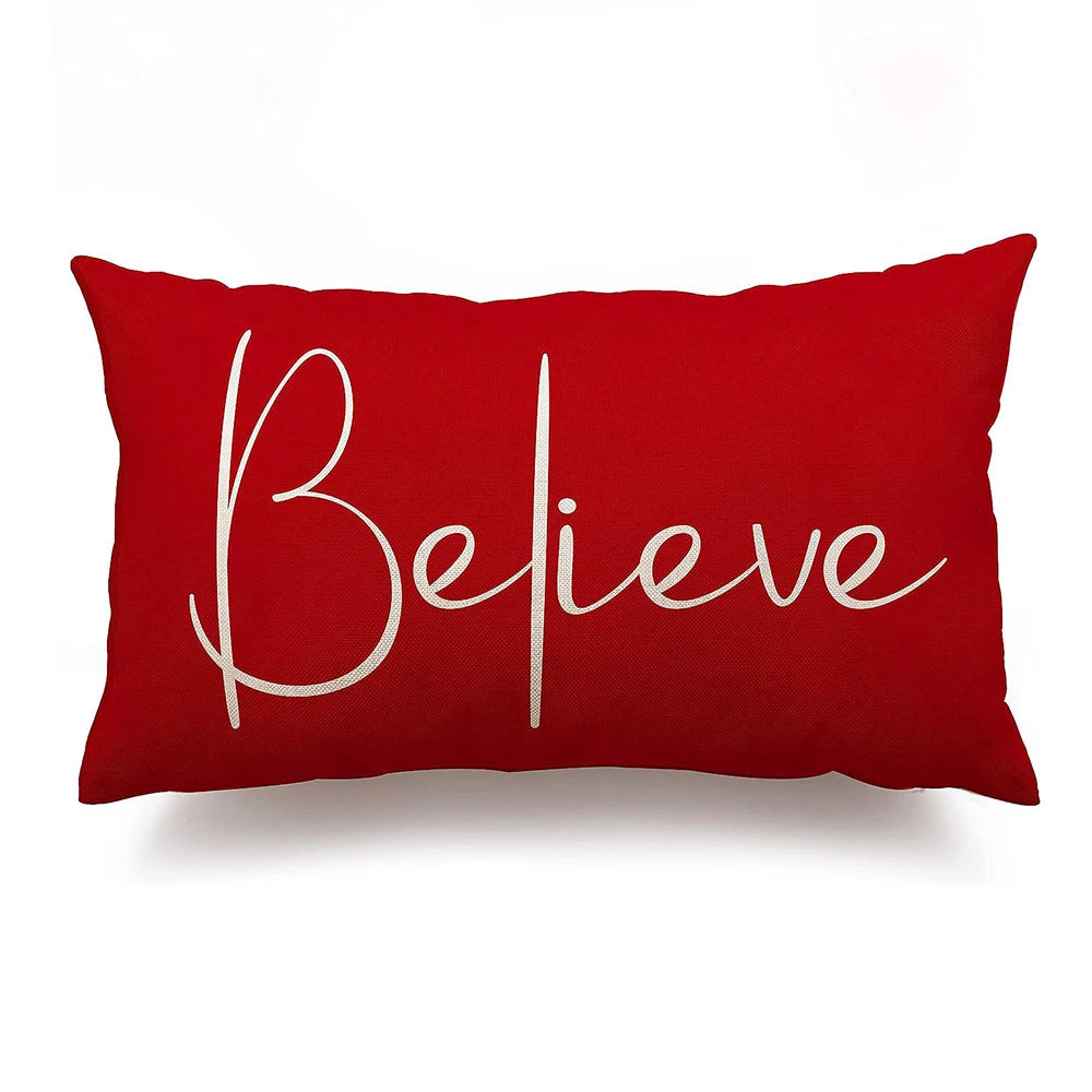 Red pillow with 'Believe' text on a white background