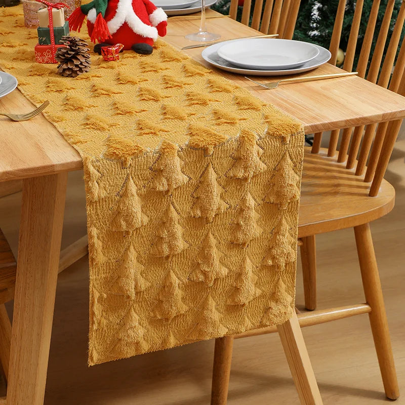 Yellow textured table runner on a wooden table with Christmas decorations.