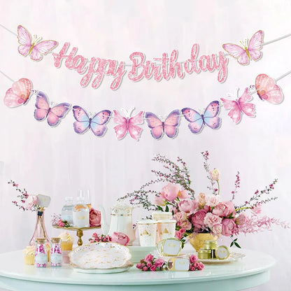 Birthday party setup with butterfly-themed decorations and a 'Happy Birthday' banner.