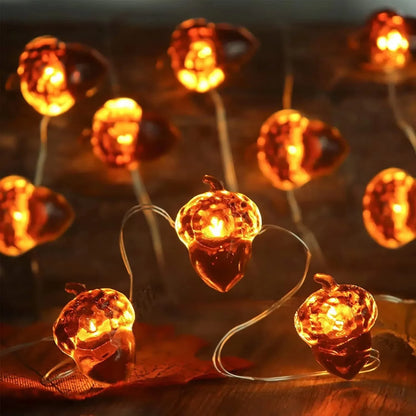 String lights shaped like acorns on a wooden surface