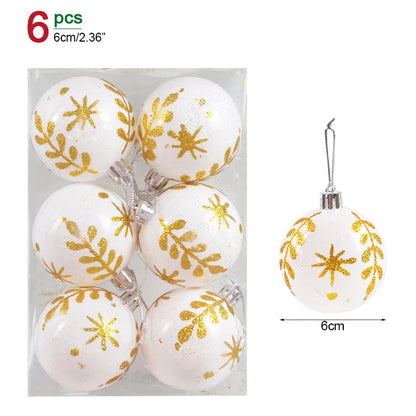 Set of six white Christmas ornaments with gold snowflake patterns in packaging