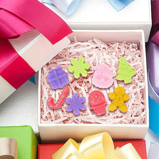 Colorful gingerbread-themed bath bombs in a gift box with ribbons.