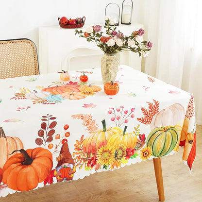 Tablecloth with autumn-themed design featuring pumpkins, leaves, and flowers on a table.