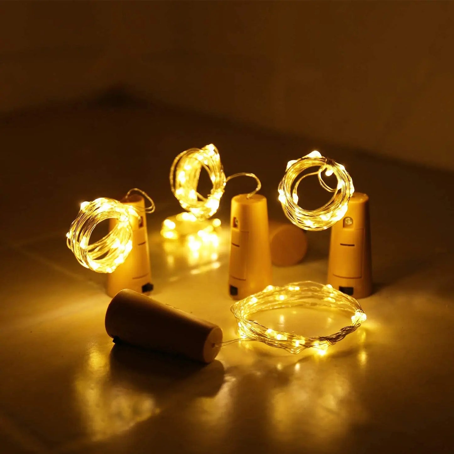 Set of wine bottle cork string lights on a dark surface