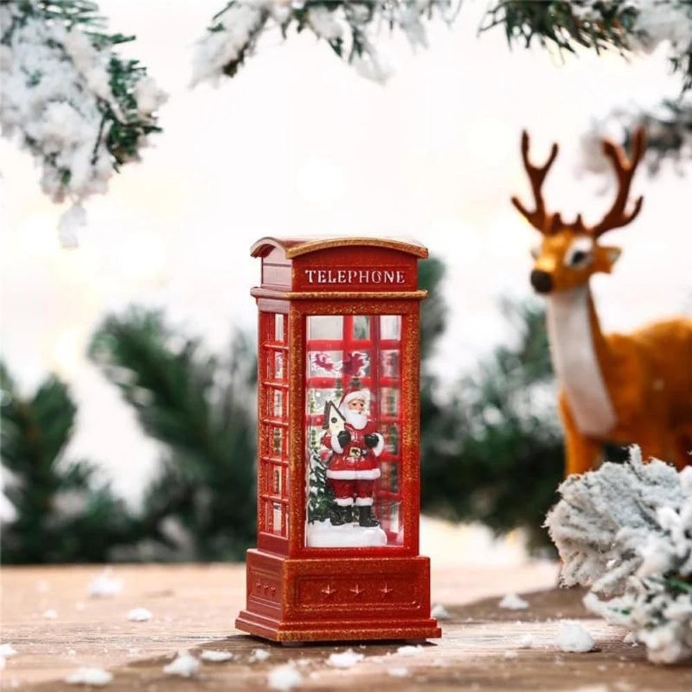 Decorative red telephone box with Santa Claus figure, surrounded by festive elements like a deer and snow-covered branches.