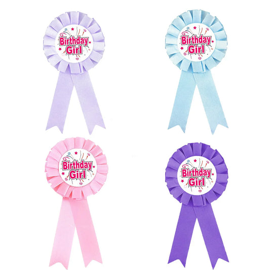 Four 'Birthday Girl' ribbons in different colors on a white background
