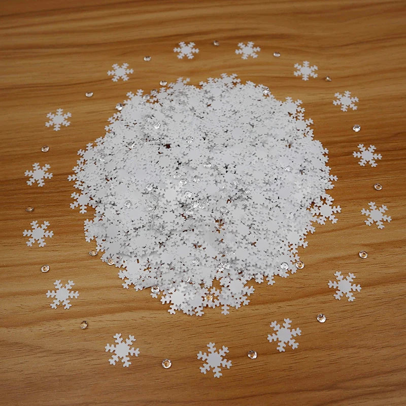 White snowflake-shaped confetti on a wooden surface