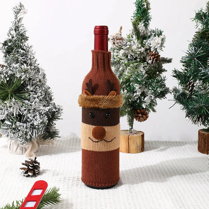 Knitted reindeer wine bottle cover with Christmas trees in the background