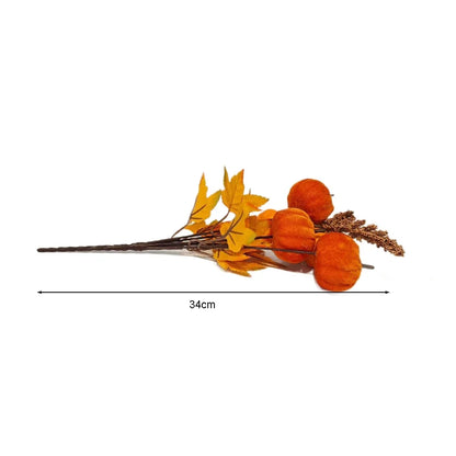 Artificial pumpkin and leaf arrangement with measurement on a white background