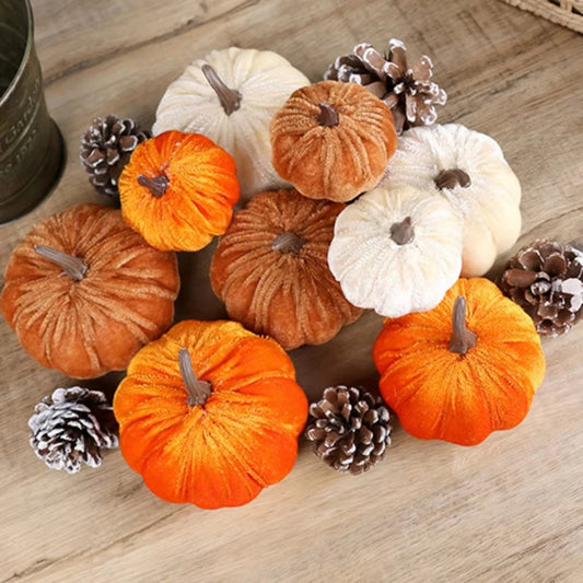 Decorative pumpkins and pinecones on a wooden surface