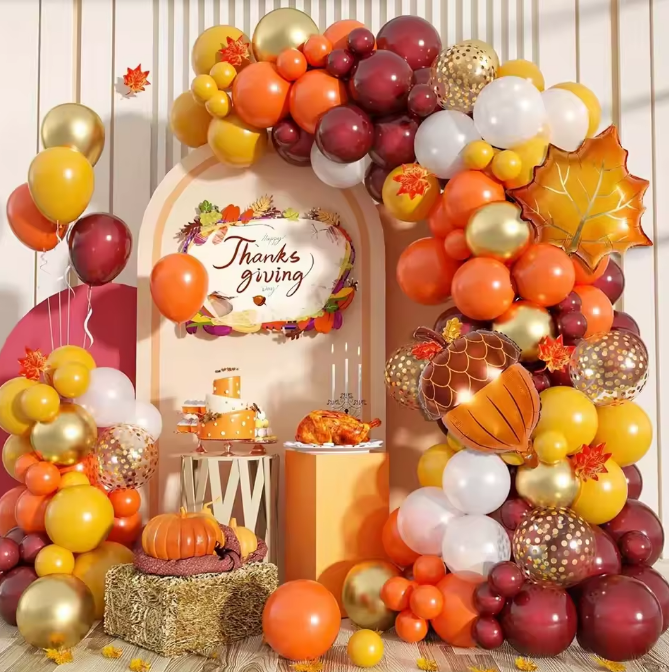 Decorative arch with balloons and Thanksgiving-themed decorations