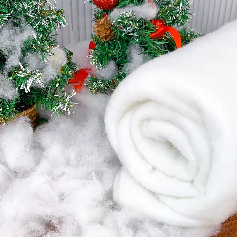 White snow blanket with Christmas decorations in the background