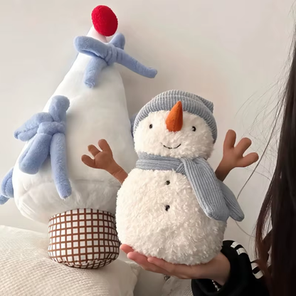 Two plush toys, one resembling a chicken and the other a snowman, held by a person against a neutral background.