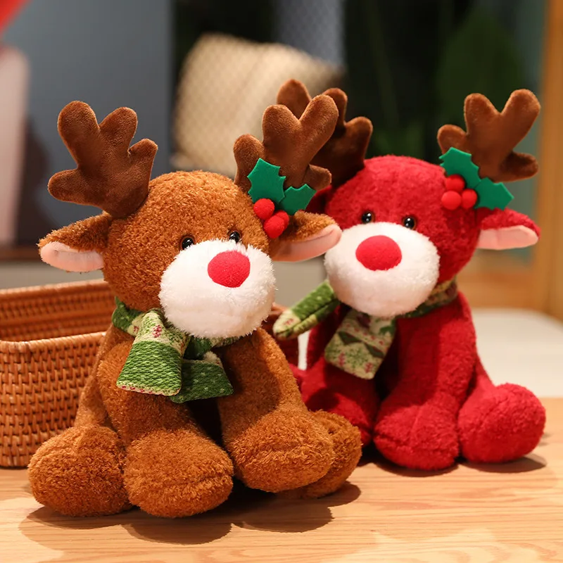 Two plush reindeer toys with festive decorations on a wooden surface.